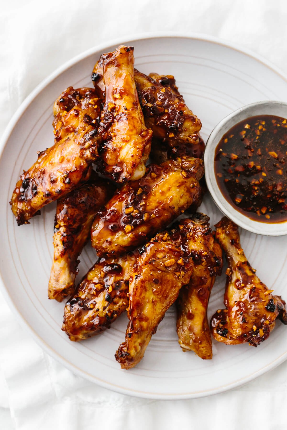 Soy garlic ginger chicken wings are a sticky, sweet and flavorful appetizer with a kick! The perfect party or Super Bowl recipe! Soy garlic ginger chicken wings on a plate.
