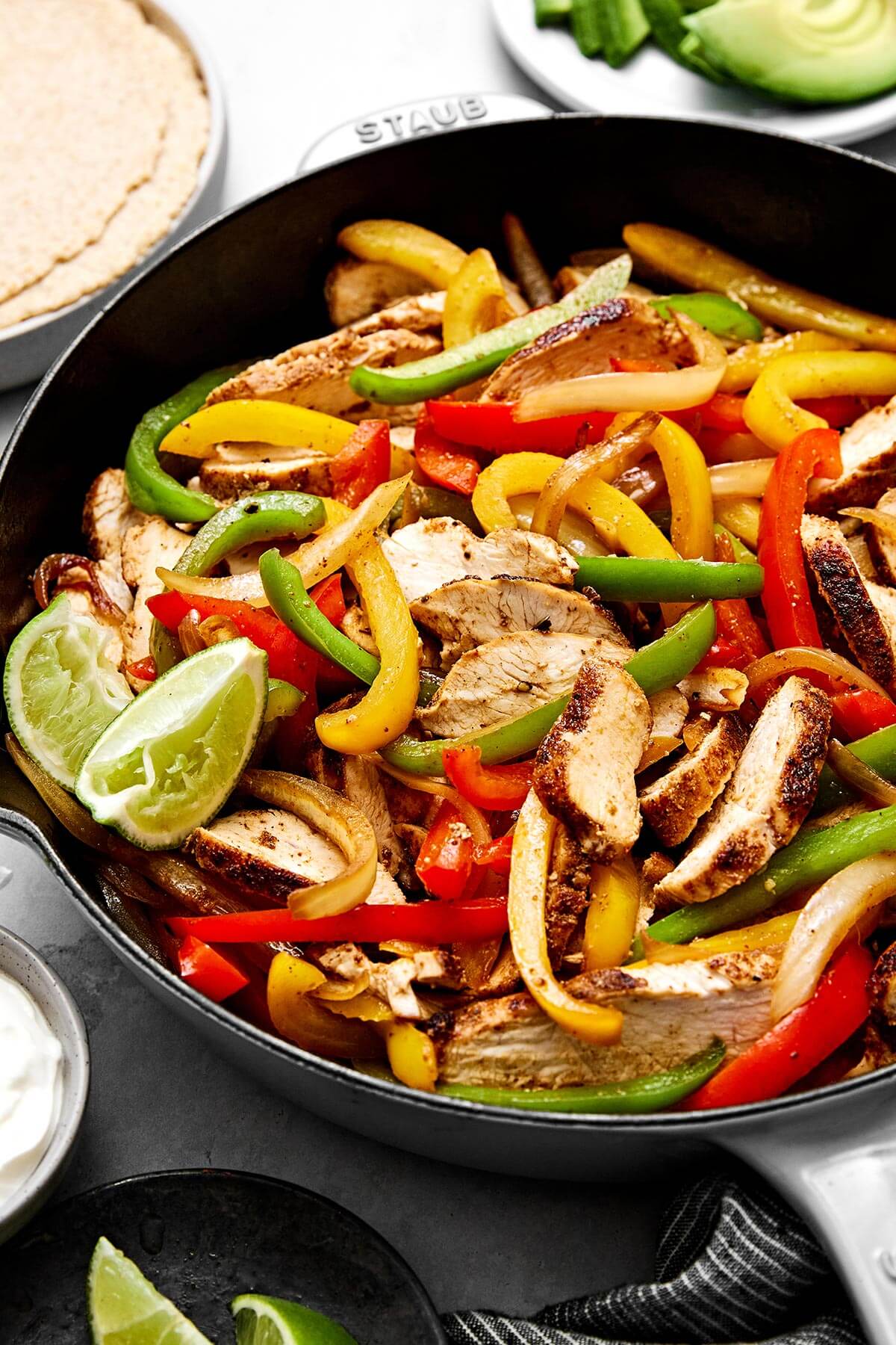 Enjoy these easy chicken fajitas with chicken and vibrant veggies tossed in the best fajita seasoning. Wrap them in tortillas for taco night! Skillet chicken fajitas.