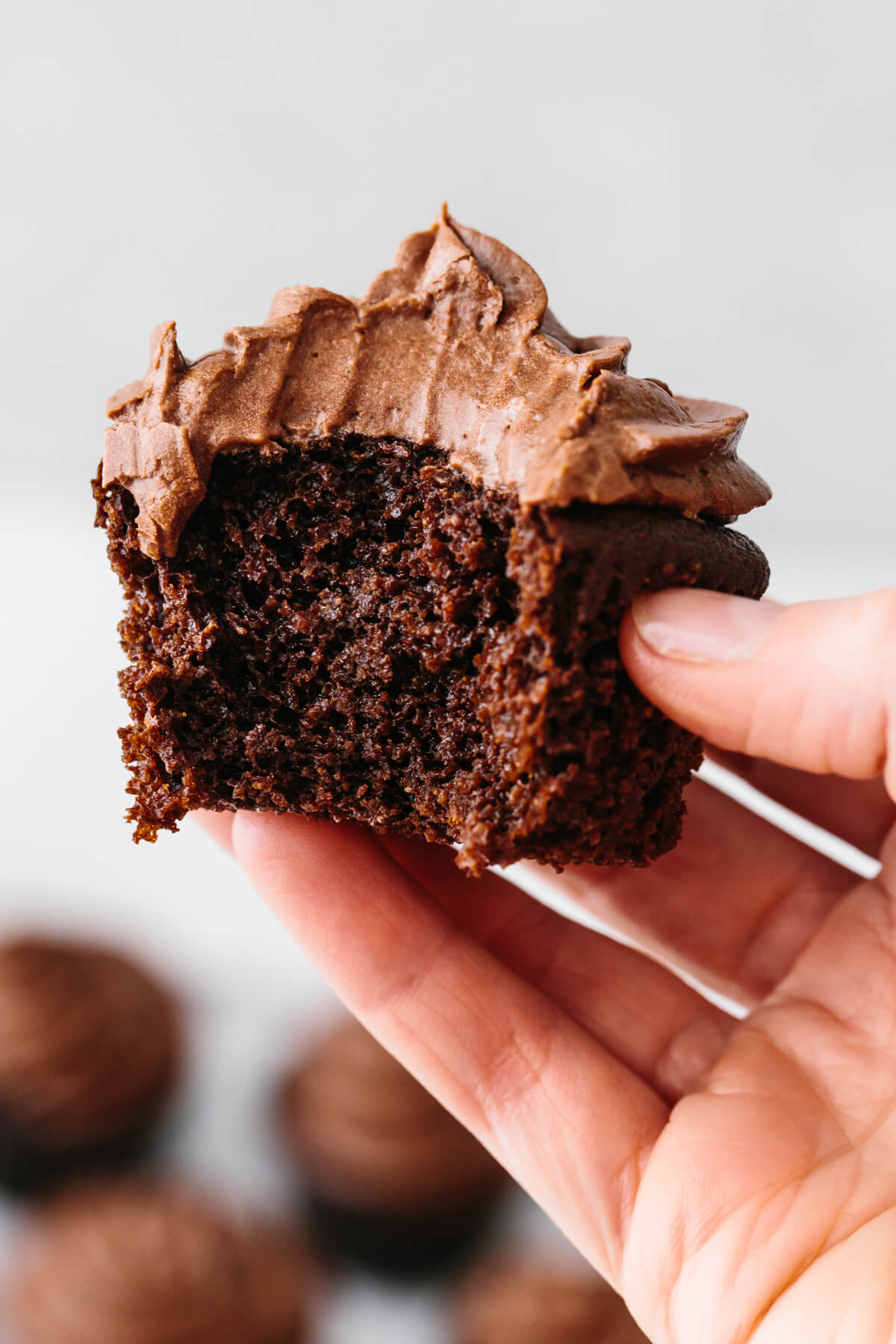 Biting into a paleo chocolate cupcake.