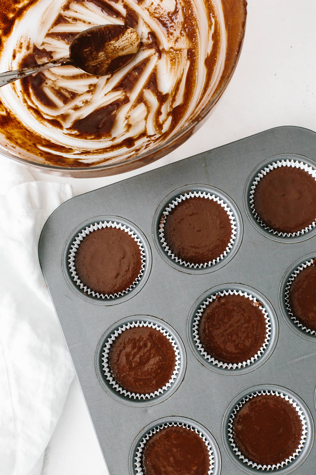 Filling the cupcake pan with chocolate batter.