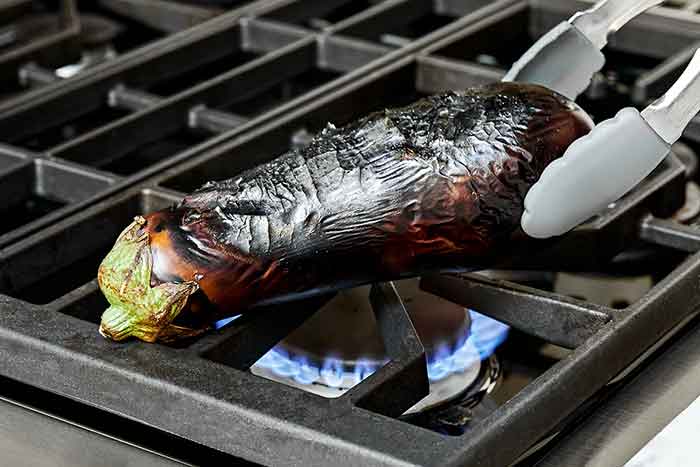 Roasted eggplants over flame.