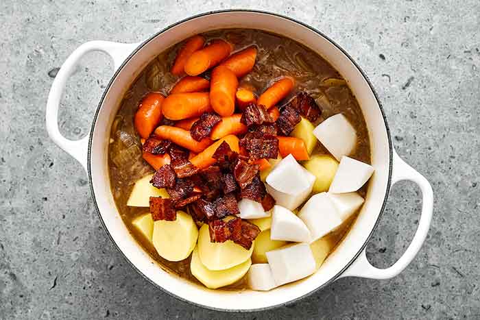 Step seven of lamb stew: Add the veggies.
