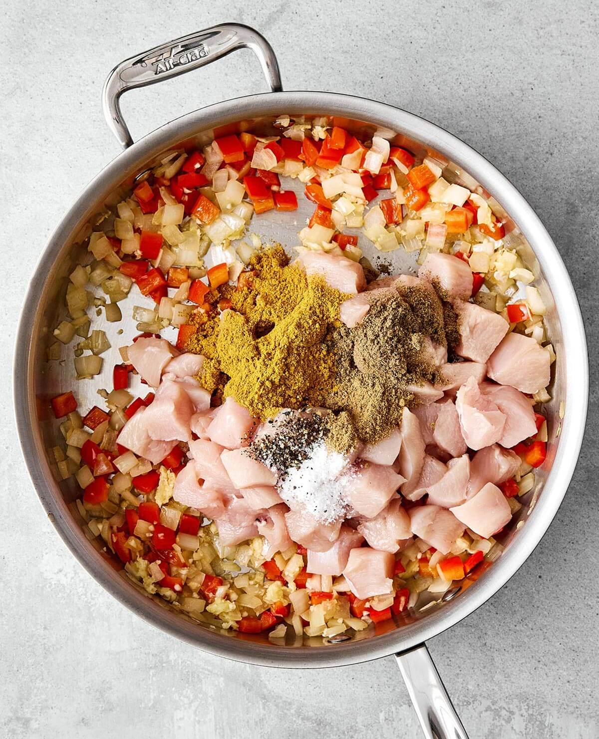 Cooking chicken with curry spices.