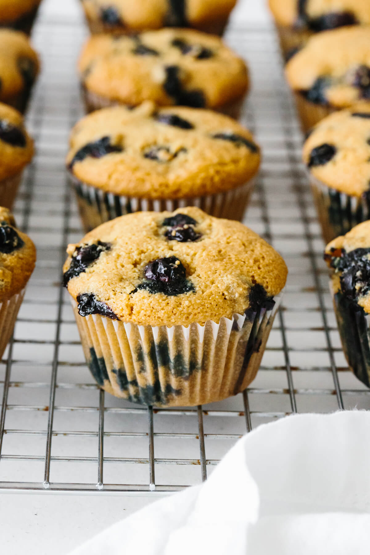 Paleo blueberry muffins are sweet, moist and fluffy! They're also gluten-free and dairy-free. Paleo blueberry muffins on a cooling rack.