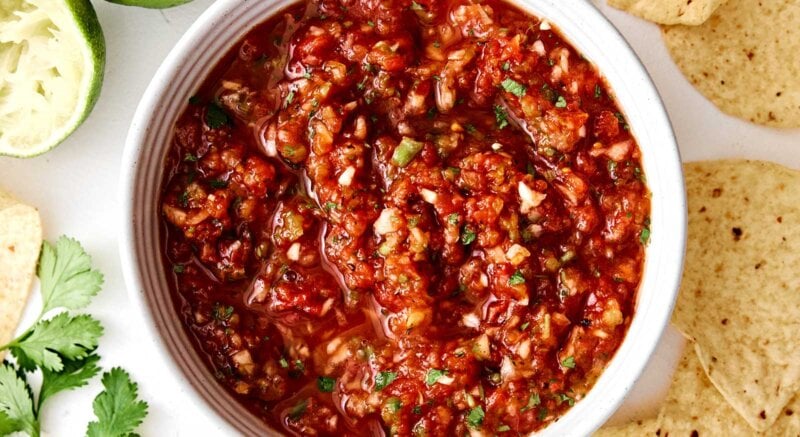 Red salsa in a bowl with chips.
