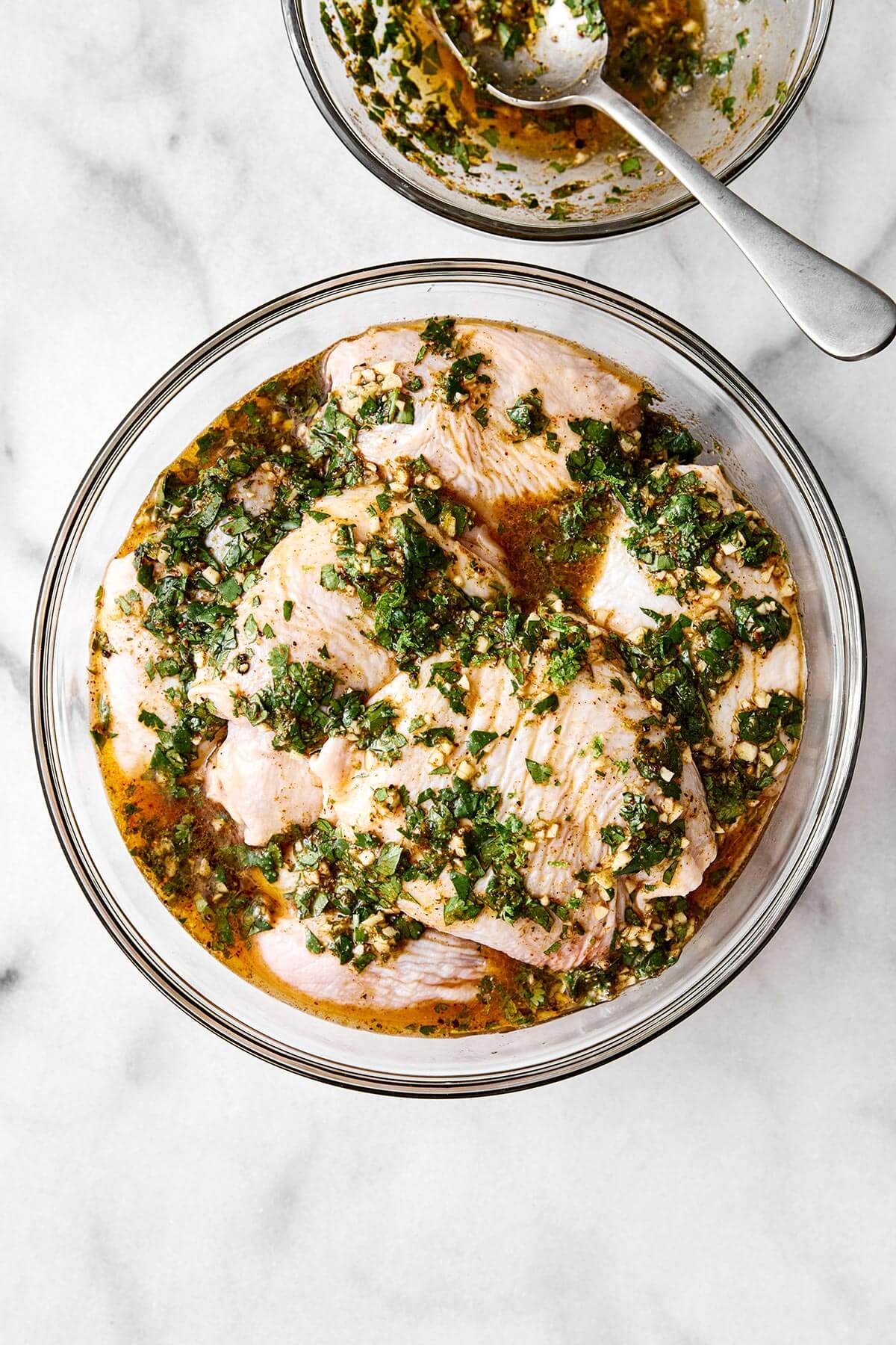 This cilantro lime chicken is incredibly juicy, bursting with bright flavors, and an easy weeknight dinner everyone will love. Chicken thighs marinating in a cilantro lime marinade.