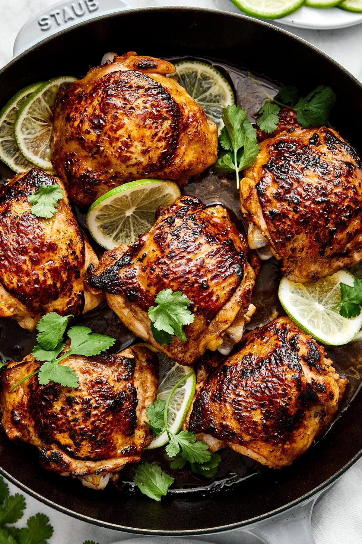 This cilantro lime chicken is incredibly juicy, bursting with bright flavors, and an easy weeknight dinner everyone will love. A skillet of cilantro lime chicken thighs.