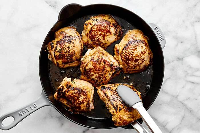 A skillet of baked cilantro lime chicken thighs.
