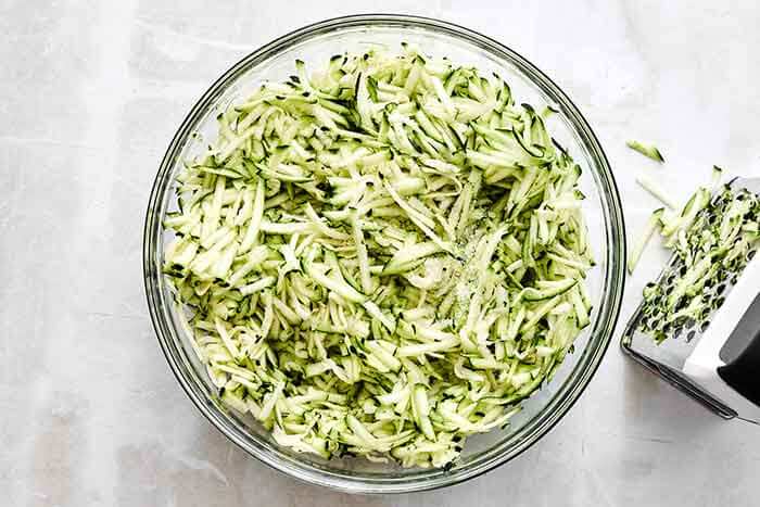 Grated zucchini in a bowl.