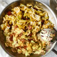 Fried cabbage in a stainless steel pan.