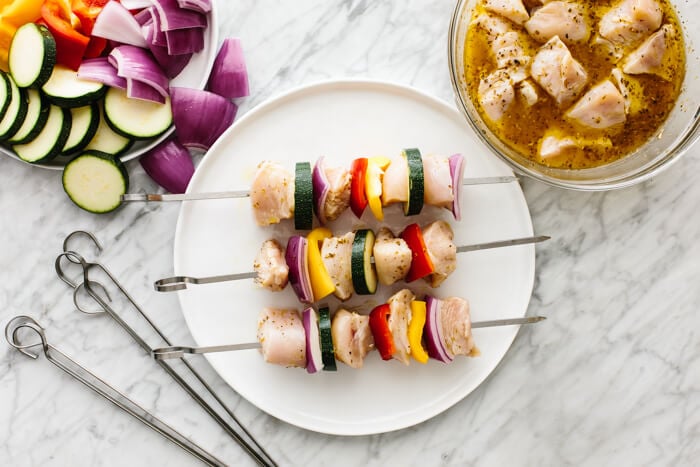 Threading chicken kabob skewers