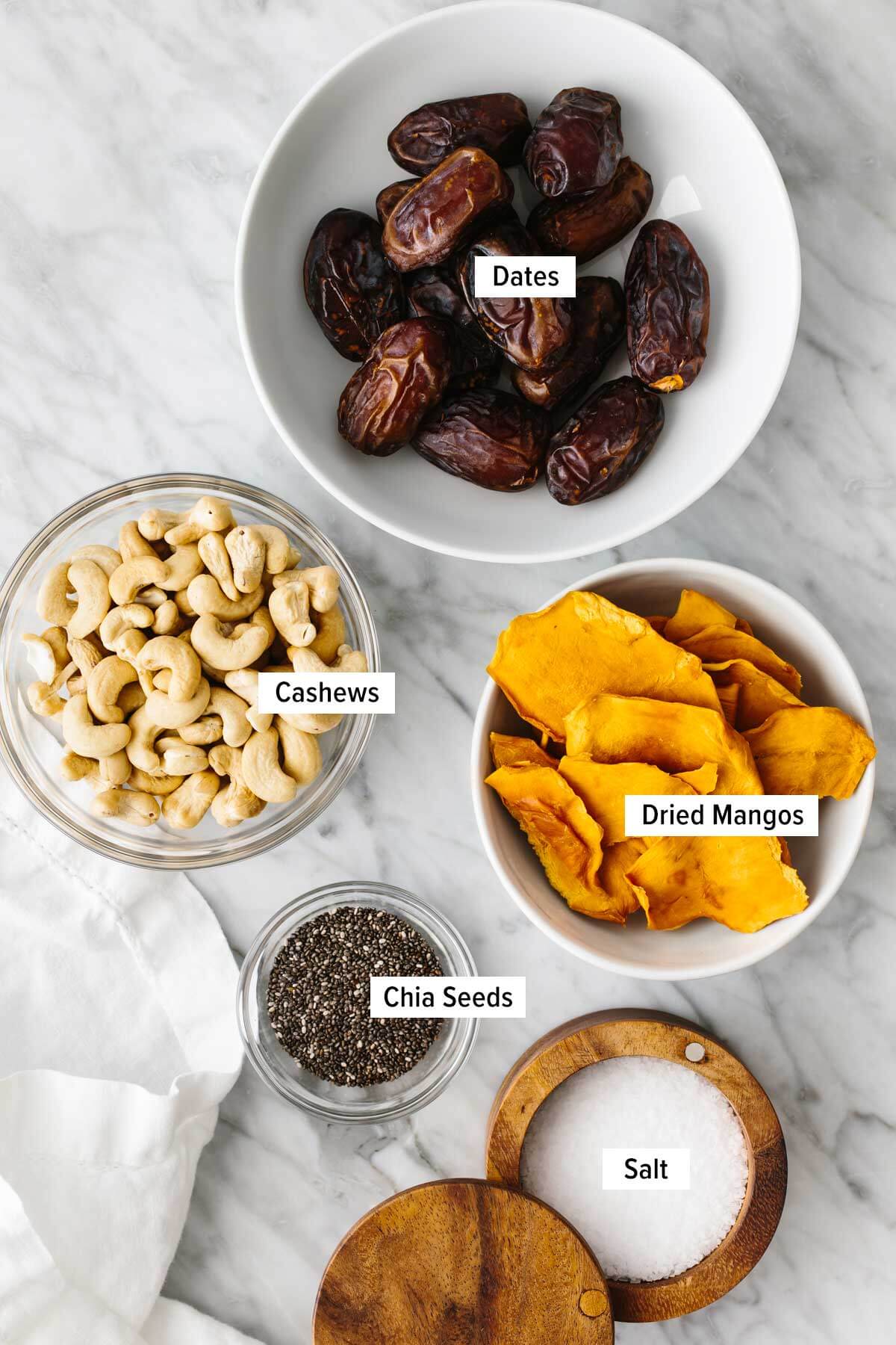 Ingredients for mango date energy balls on a table.