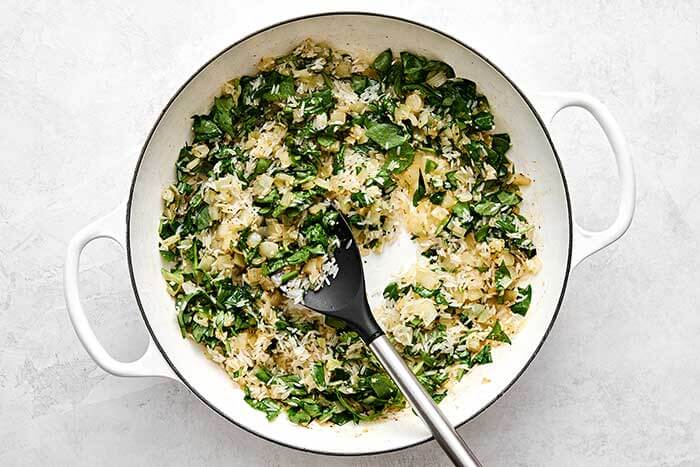 Cooking rice and veggies in a pan.