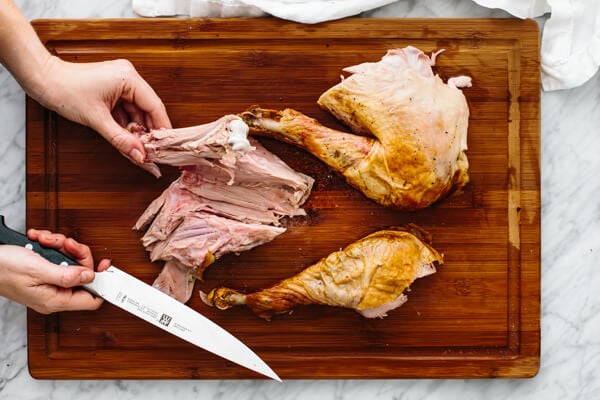 Removing the thigh bone from a carved turkey