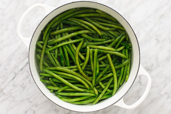 Beans being boiled in a pot for a healthy green bean casserole.