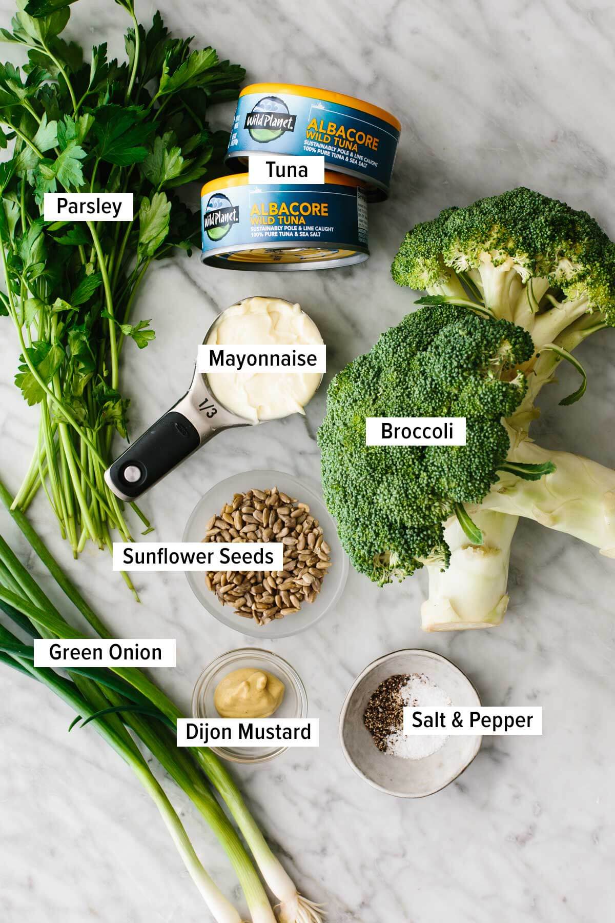 Ingredients for broccoli tuna salad on a table.