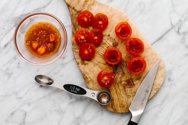 Slicing cherries for guacamole stuffed tomatoes.