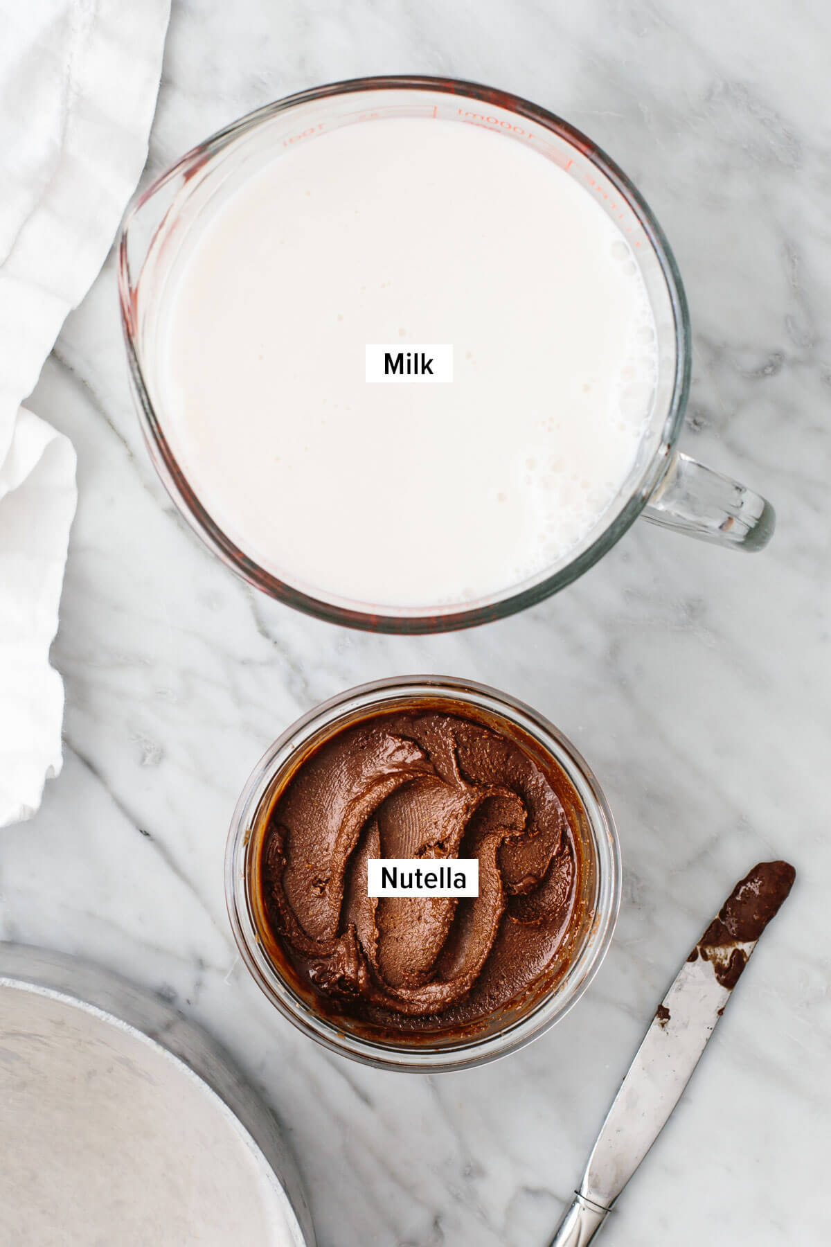 Ingredients for Nutella hot chocolate on a table.
