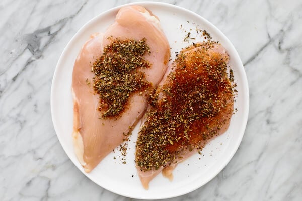 Two chicken breasts coated in spices.