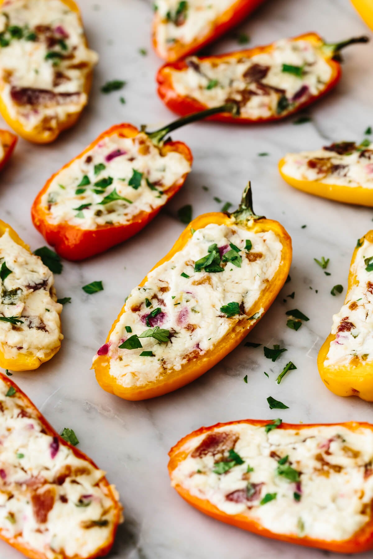 Bacon goat cheese stuffed mini peppers laid out on a table.