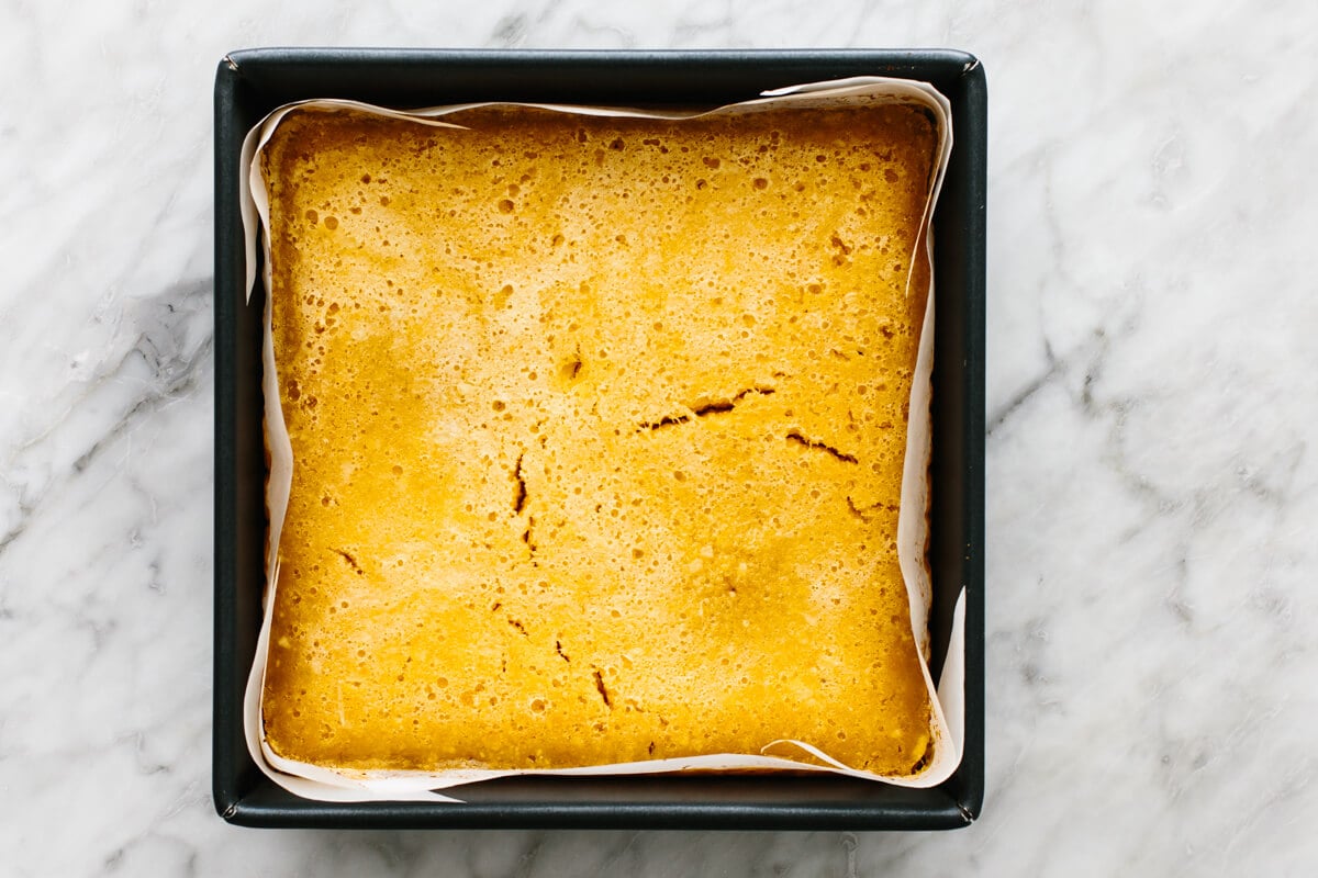These lemon bars have a gluten-free shortbread-like crust and a bright, luscious filling that's the perfect balance of sweet and tangy! Baking lemon bars in a pan.