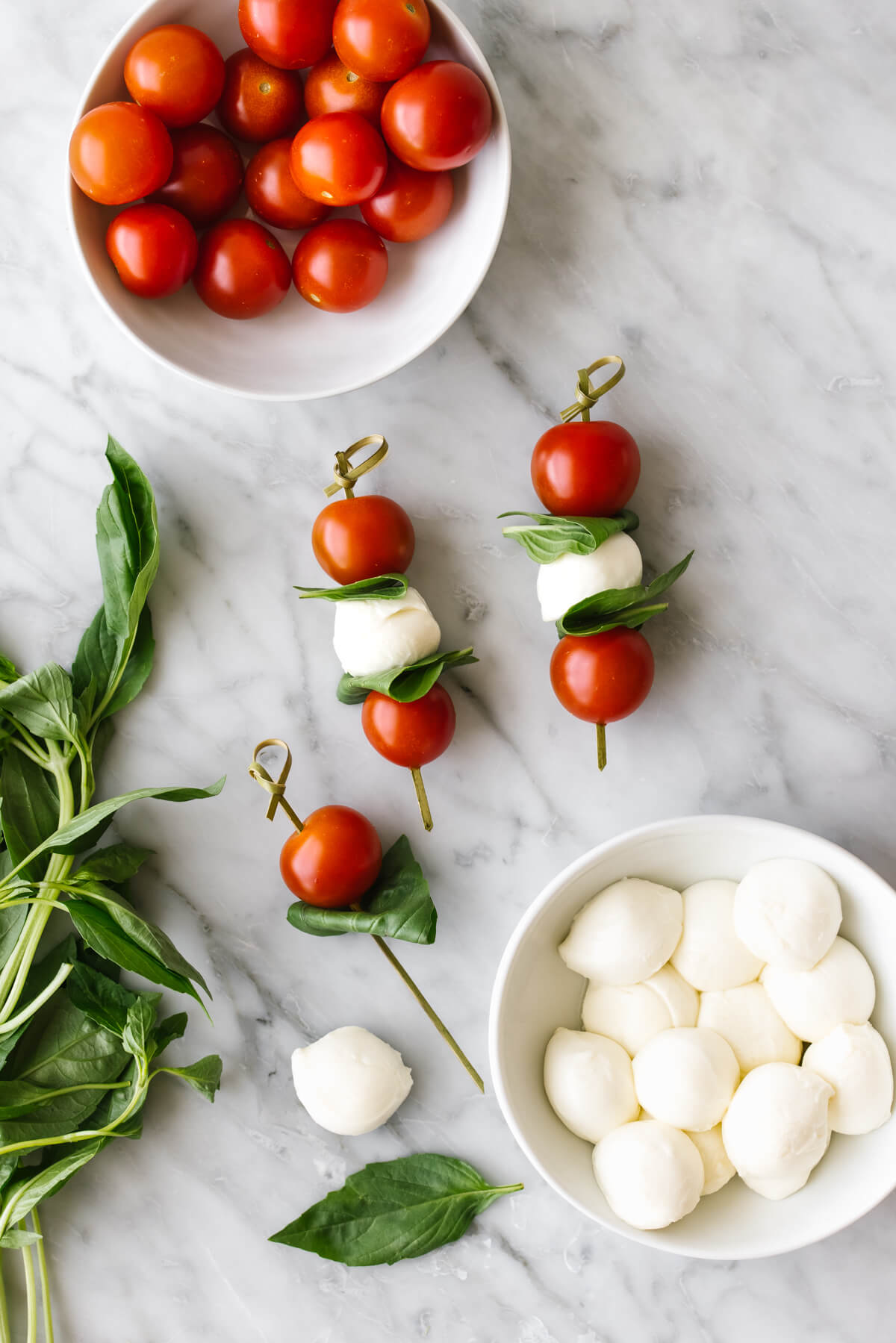 Making caprese skewers on a table