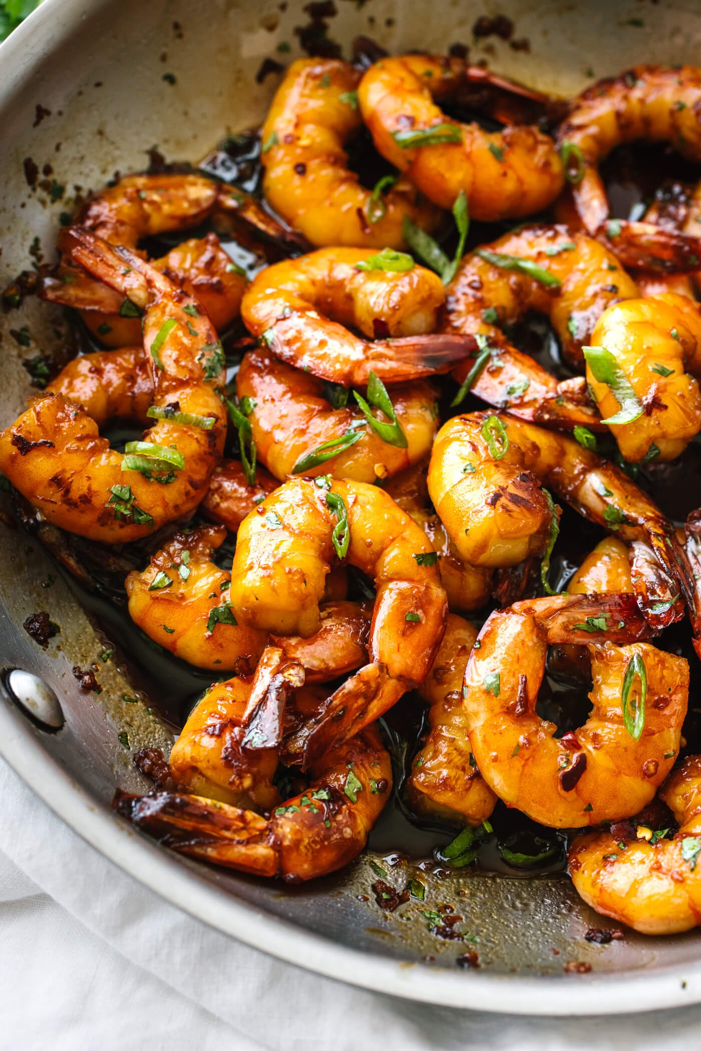 A metal pan with honey garlic shrimp in it