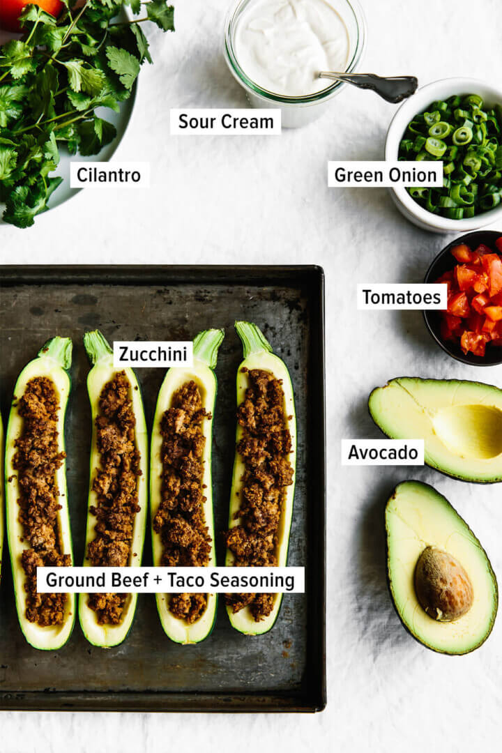 Ingredients for making taco stuffed zucchini boats on a table.