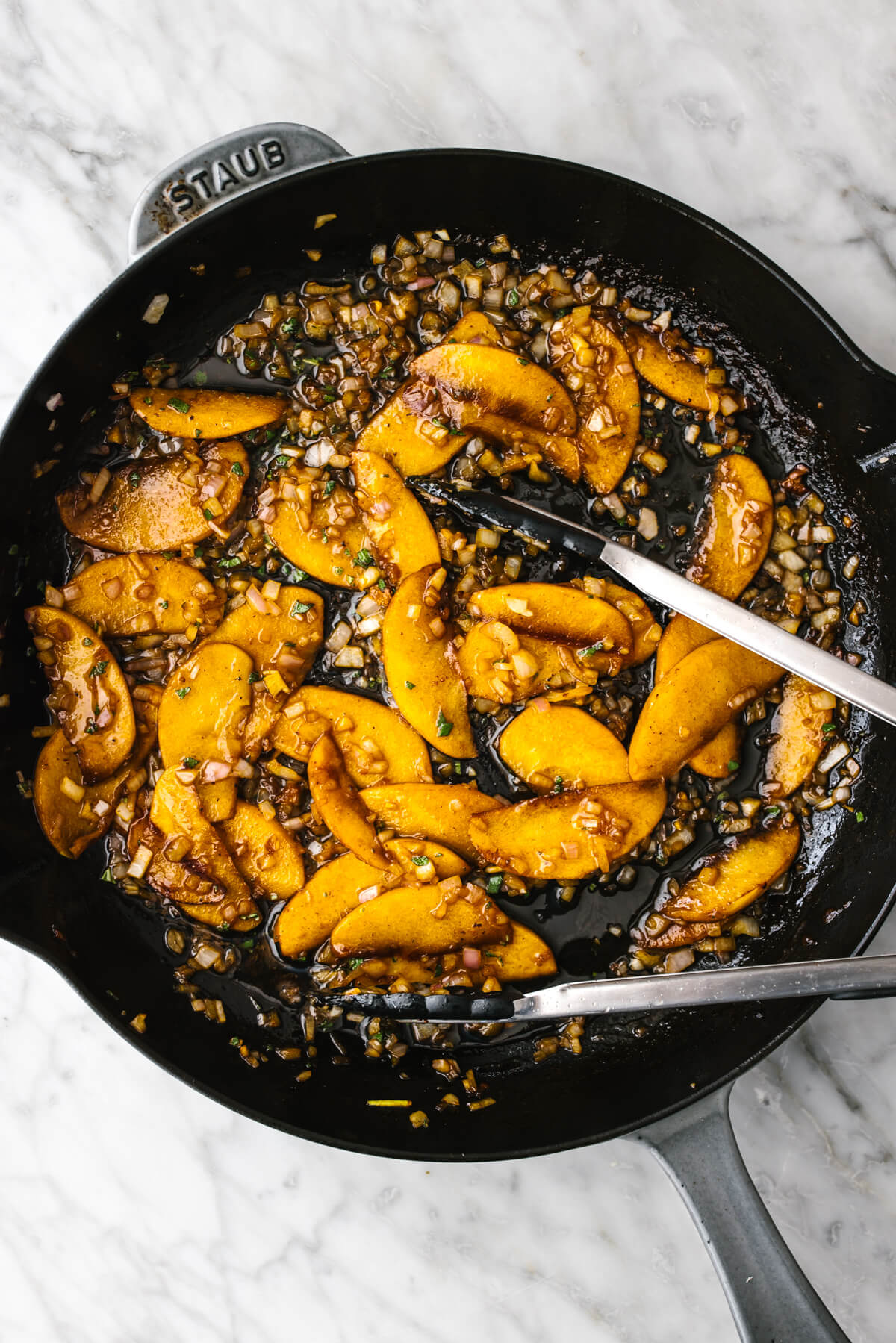 Making apple cider sauce in skillet for pork chops