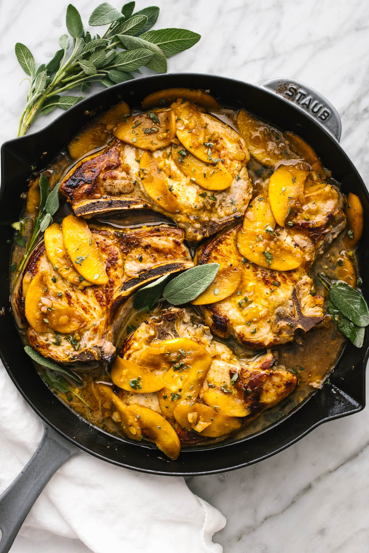 Apple cider sage pork chops in a skillet