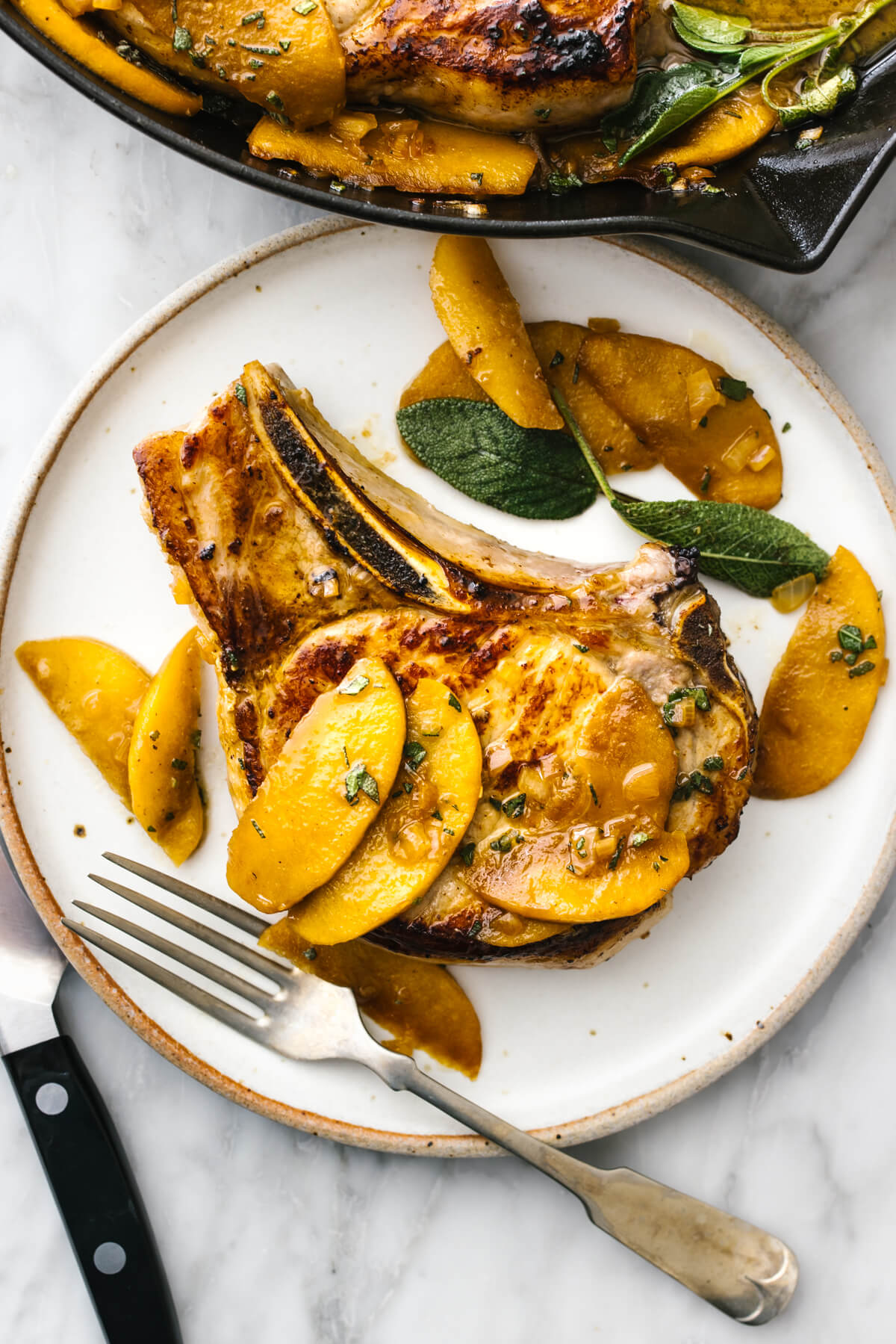 Apple cider sage pork chops on a plate with fork