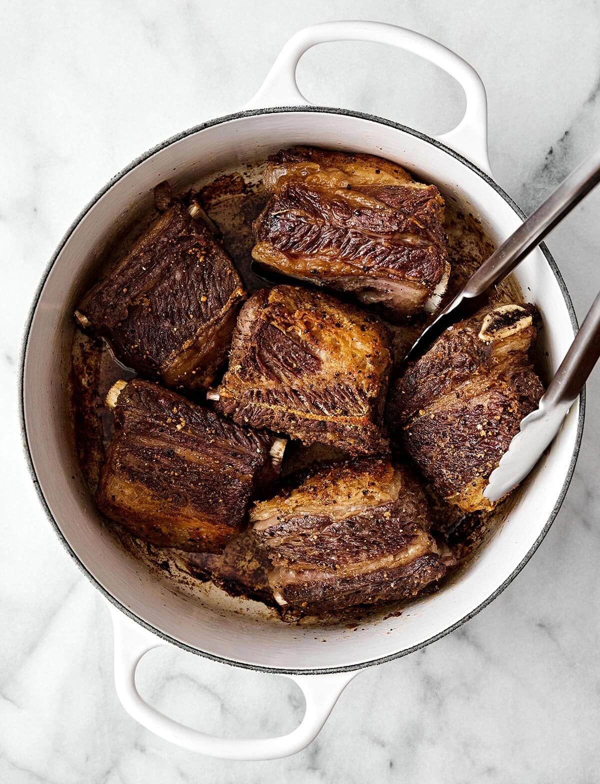 Seared short ribs in a pot.