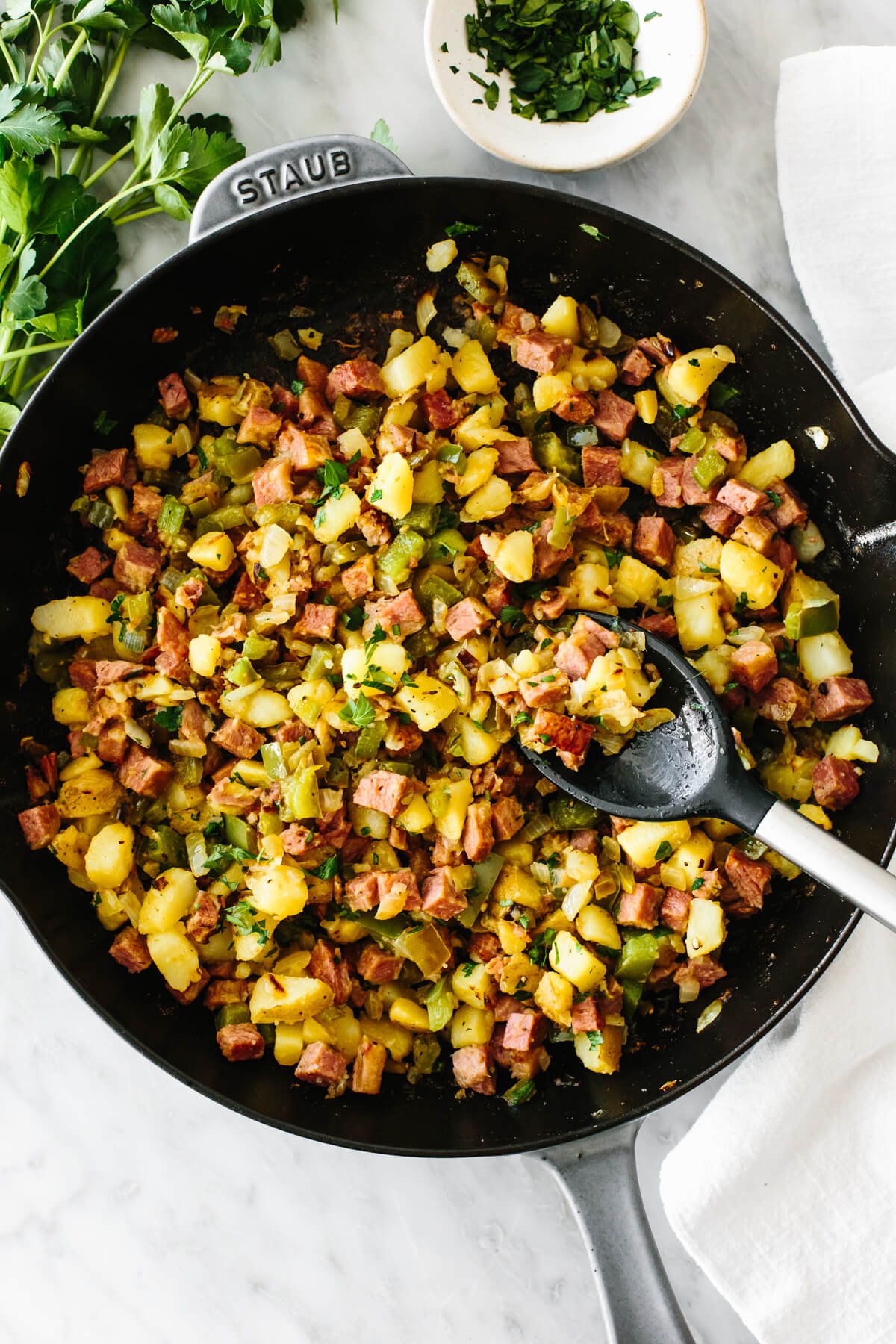 Corned beef hash in a skillet with a spoon