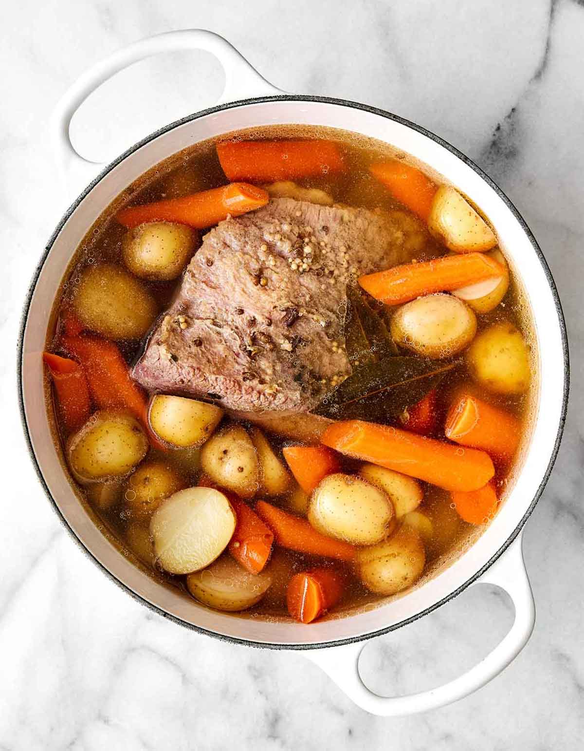 Step two of corned beef and cabbage: Add the potatoes and carrots.