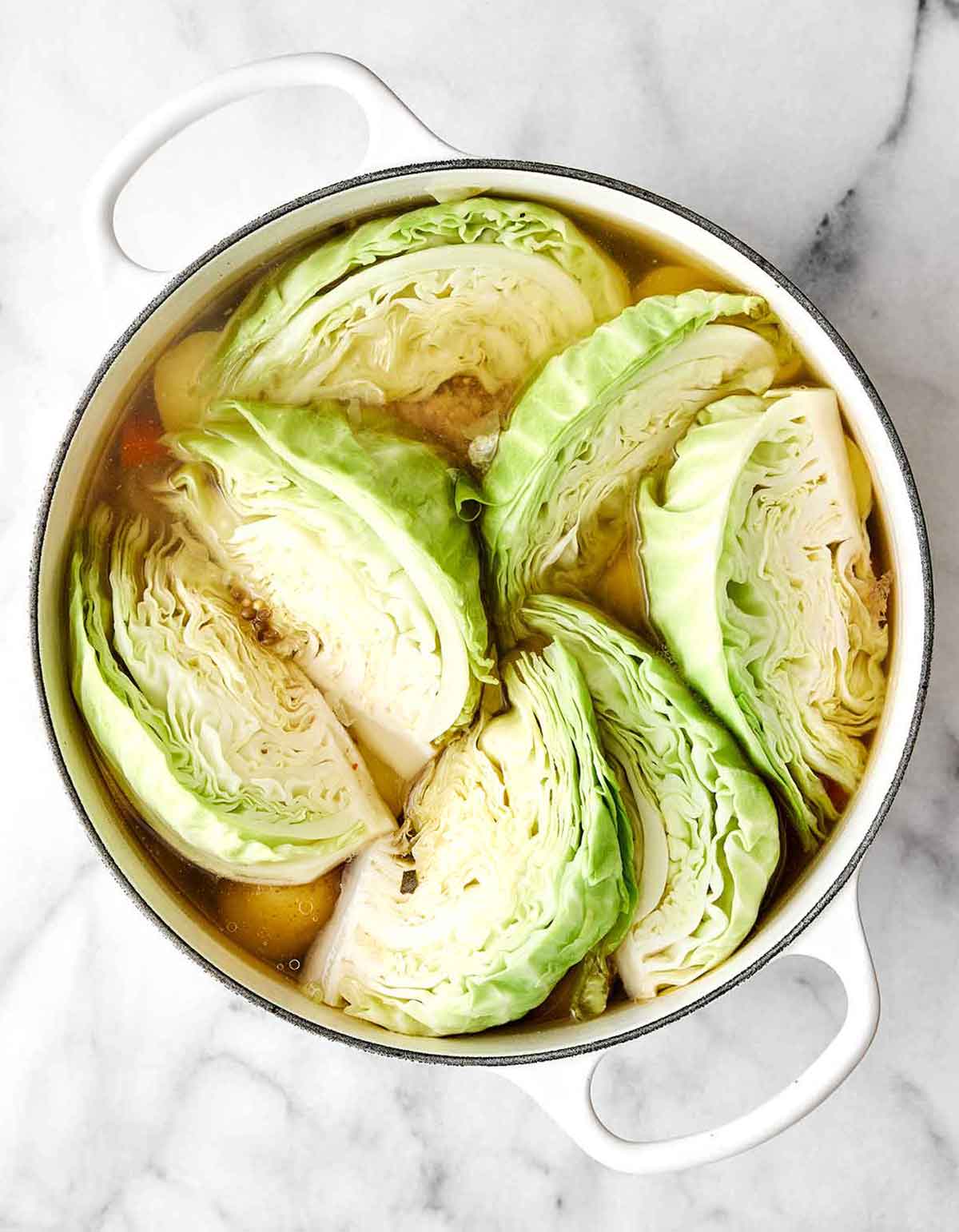Step three of corned beef and cabbage: Add the cabbage.