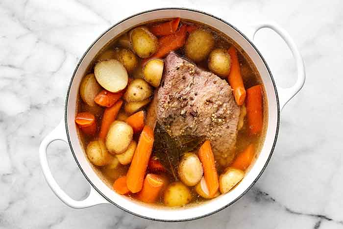 Step two of corned beef and cabbage: Add the potatoes and carrots.