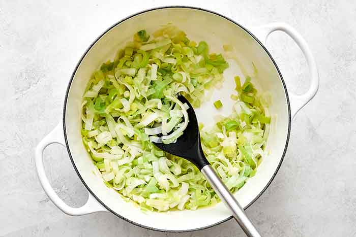 Cooking leeks in a pot.