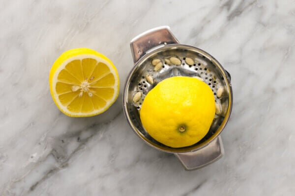 Half a lemon on a metal juicer