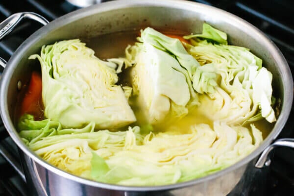 A steel pot with corned beef and cabbage