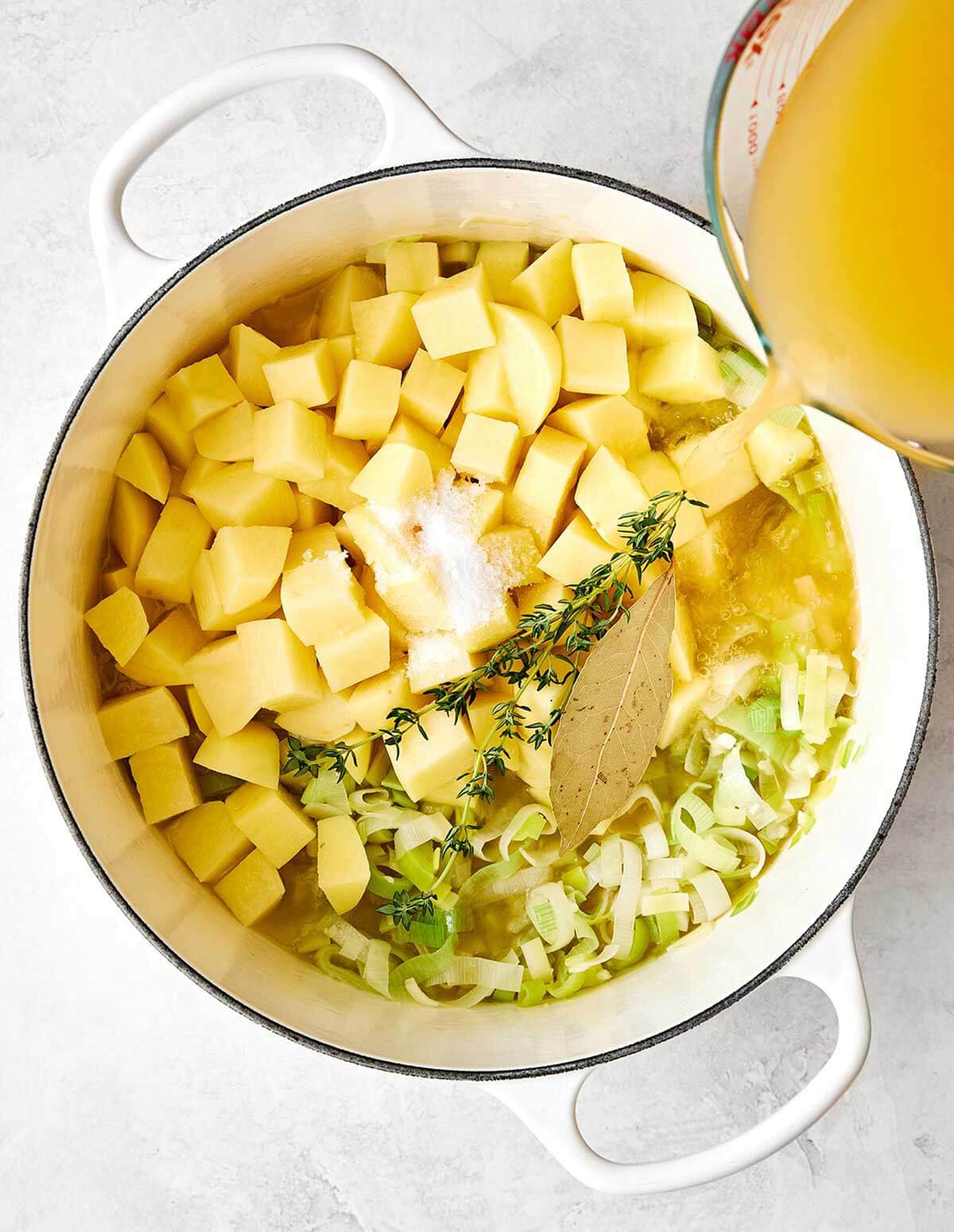This potato leek soup is the ultimate fall soup! It's ultra-creamy, loaded with veggies, and completely vegetarian. Adding broth to potato leek soup.