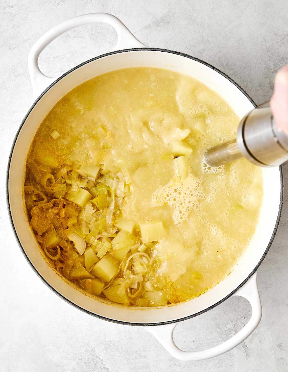 This potato leek soup is the ultimate fall soup! It's ultra-creamy, loaded with veggies, and completely vegetarian. Blending potato leek soup with immersion blender.