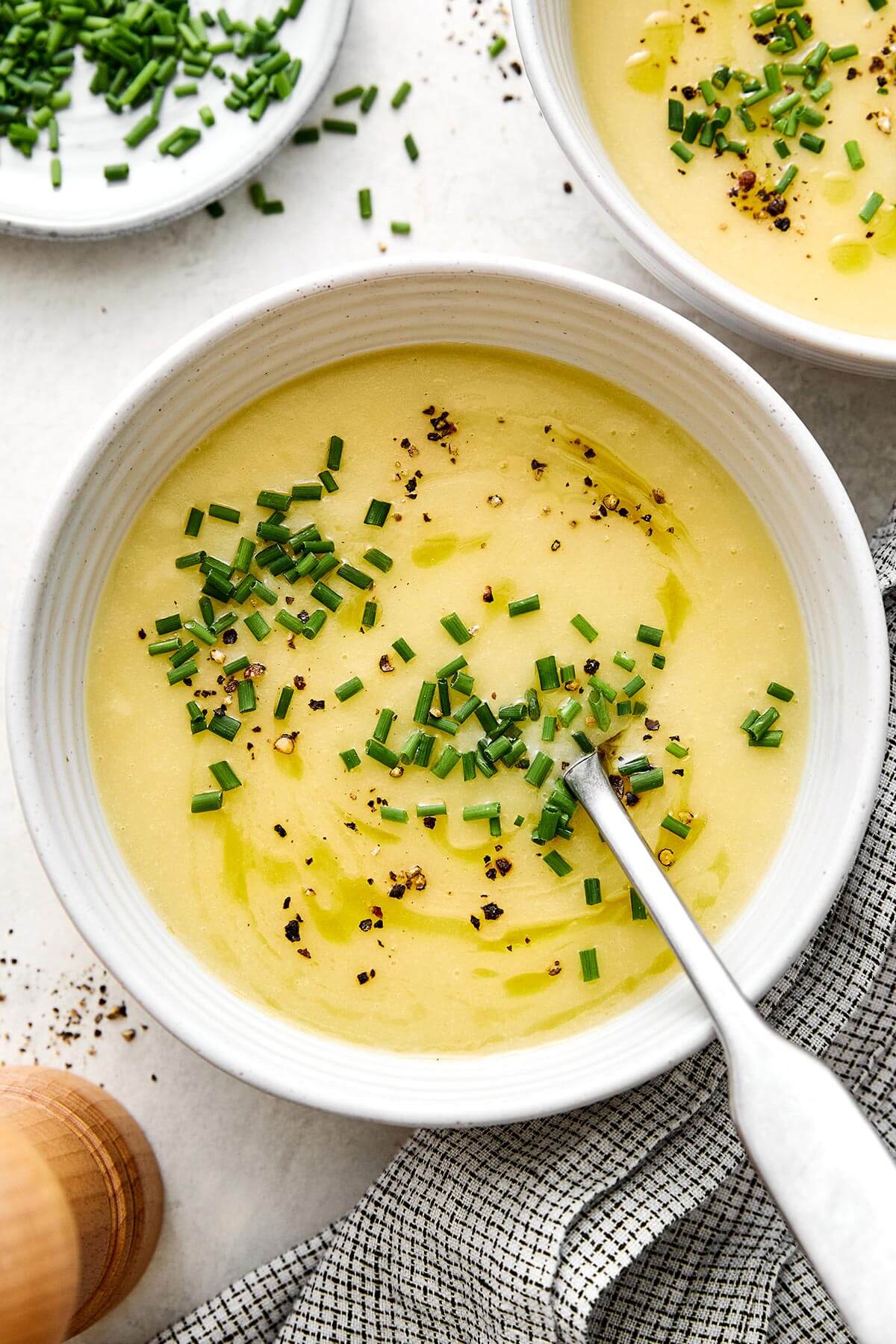 This potato leek soup is the ultimate fall soup! It's ultra-creamy, loaded with veggies, and completely vegetarian. A bowl of potato leek soup.