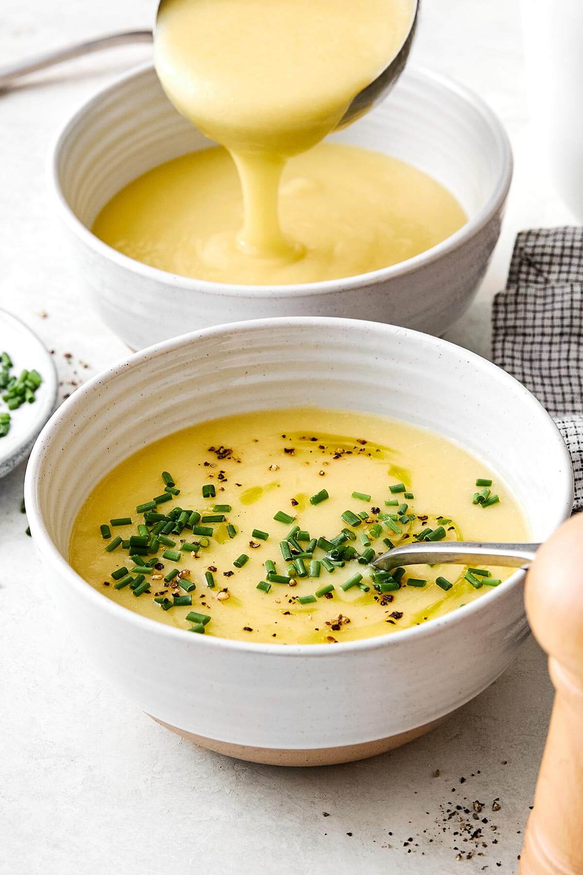 This potato leek soup is the ultimate fall soup! It's ultra-creamy, loaded with veggies, and completely vegetarian. Bowls of potato leek soup.