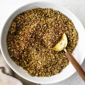 Za'atar spice in a bowl next to a napkin