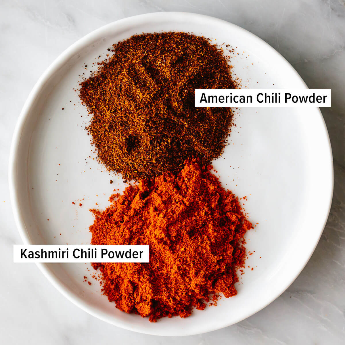 This butter chicken recipe is Indian comfort food at its best - with juicy spiced chicken tossed in a rich and velvety curry sauce. A curry recipe you won't want to miss! Chili powders on a plate for butter chicken