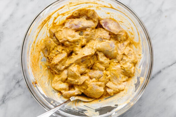 Marinated chicken in a glass bowl for butter chicken