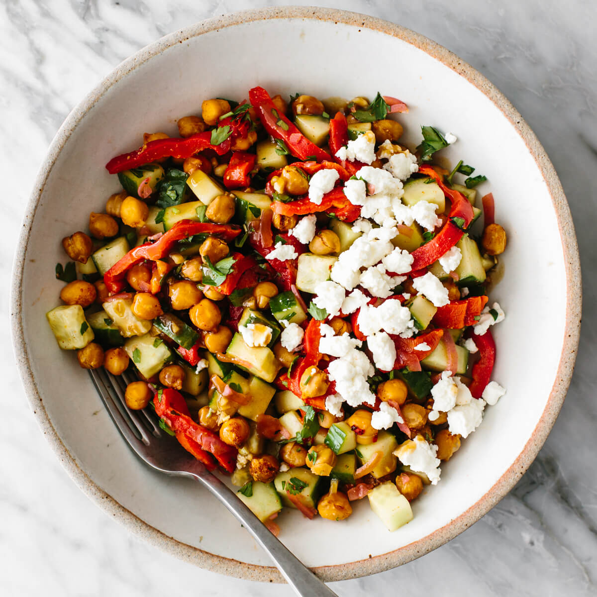 This budget meal prep shows that healthy eating doesn't have to break the bank. Turn 11 prepped ingredients into 7 meals that costs $3 or less! Chickpea salad in a bowl for budget meal prep