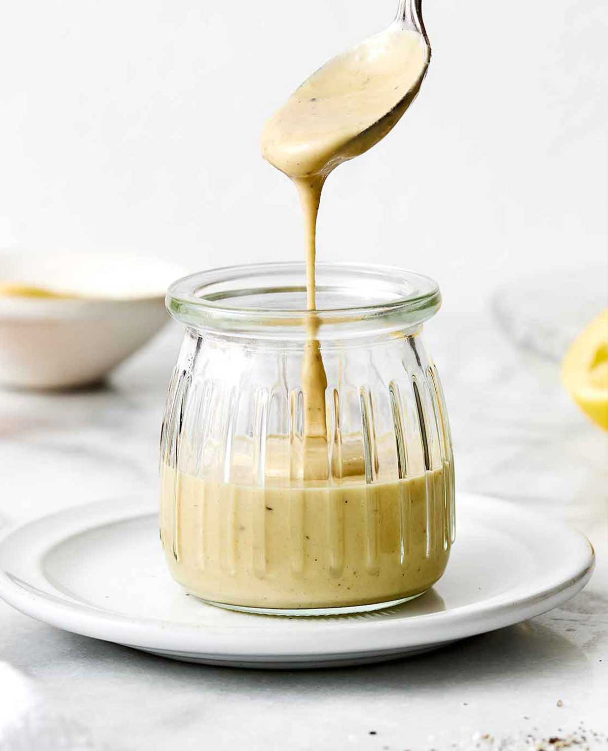 A jar of maple mustard tahini dressing.
