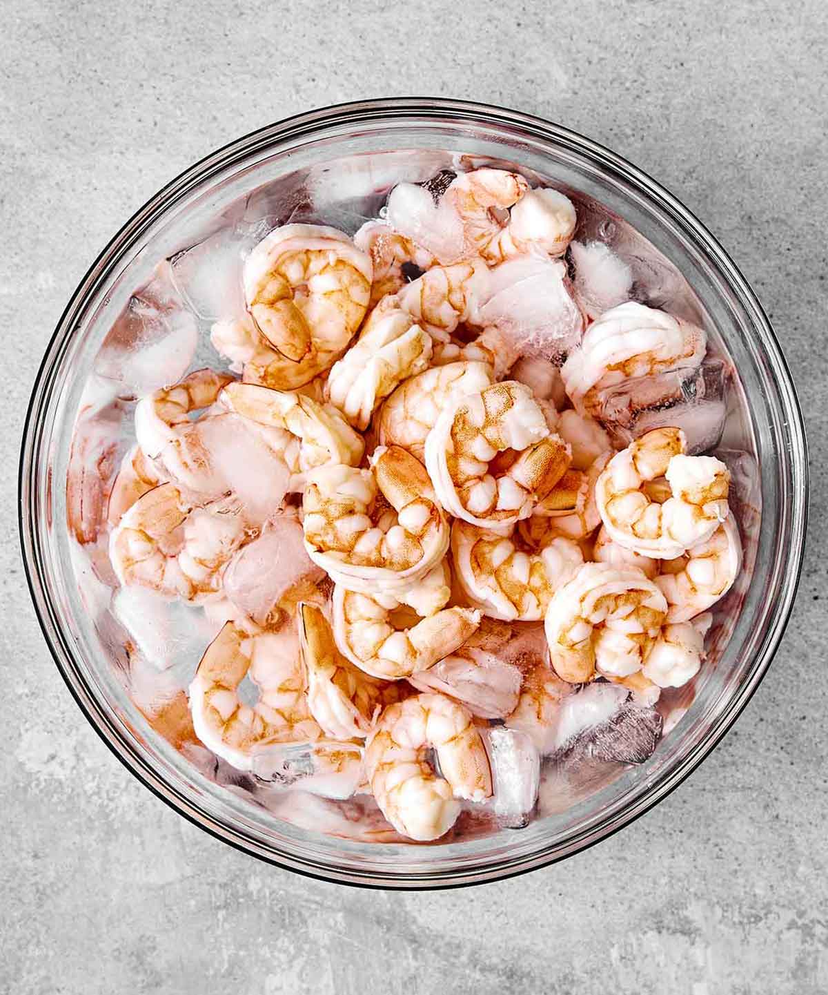 Chilling shrimp in a bowl of ice and water.