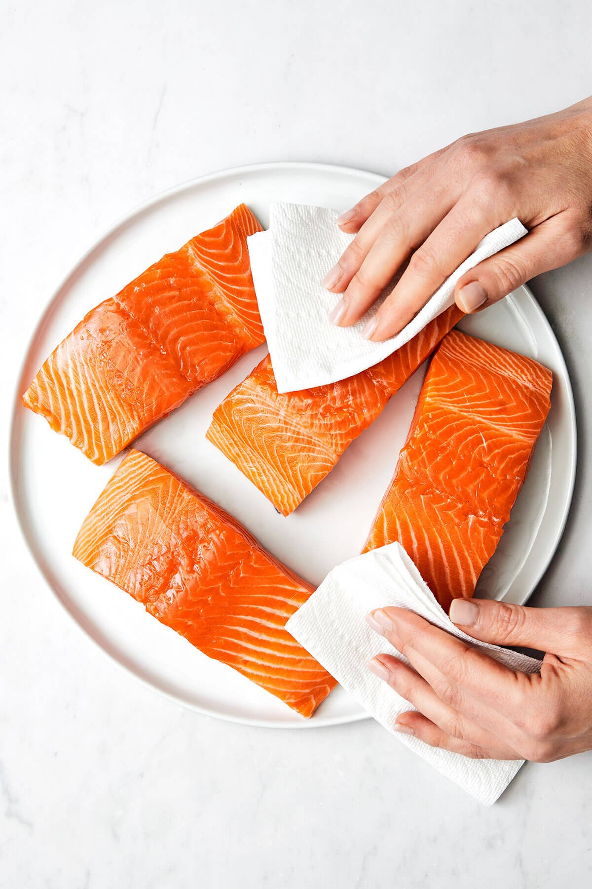 This air fryer salmon recipe is the secret to a moist and crispy filet that tastes like a million bucks - in under 15 minutes! Patting salmon dry with a paper towel.